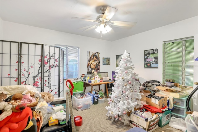 interior space with ceiling fan