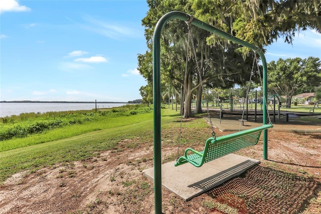 view of home's community featuring a water view and a yard