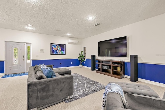 living room featuring an AC wall unit, carpet, and a textured ceiling