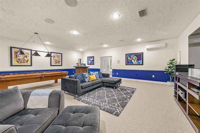 carpeted living room featuring pool table, a wall mounted air conditioner, and a textured ceiling