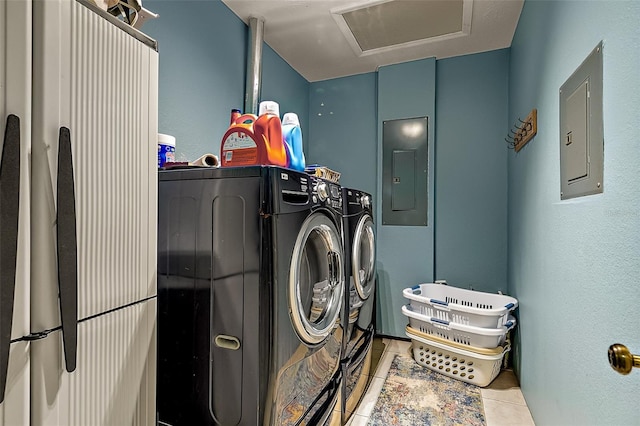 clothes washing area featuring light tile patterned flooring, independent washer and dryer, and electric panel