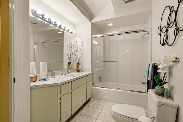 full bathroom with bath / shower combo with glass door, vanity, toilet, and tile patterned flooring