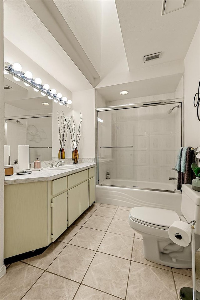 full bathroom with tile patterned floors, vanity, toilet, and combined bath / shower with glass door