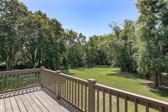 wooden terrace featuring a yard