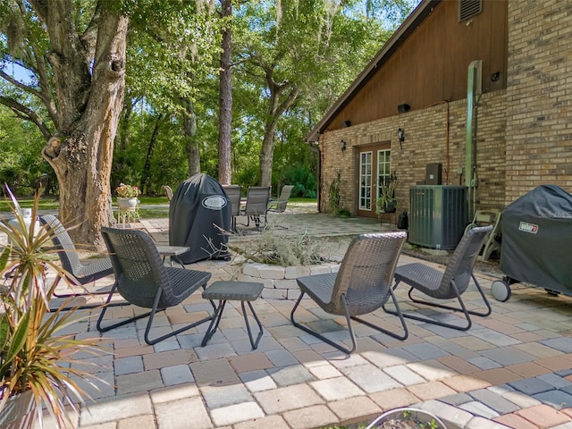 view of patio / terrace with a grill and central air condition unit