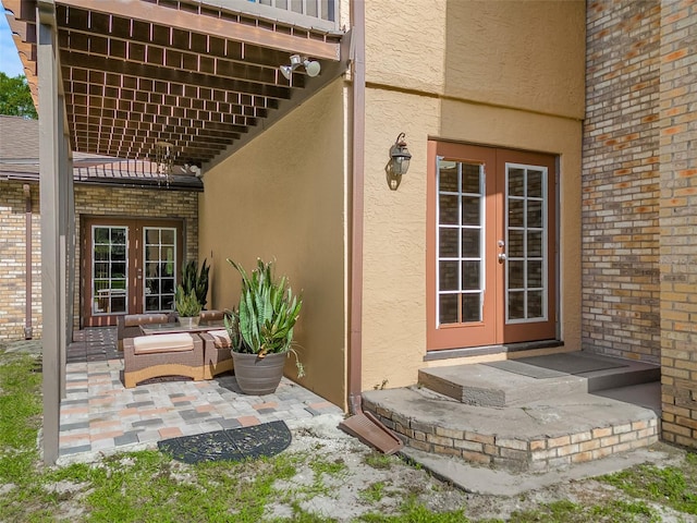 doorway to property with a patio, an outdoor living space, and french doors