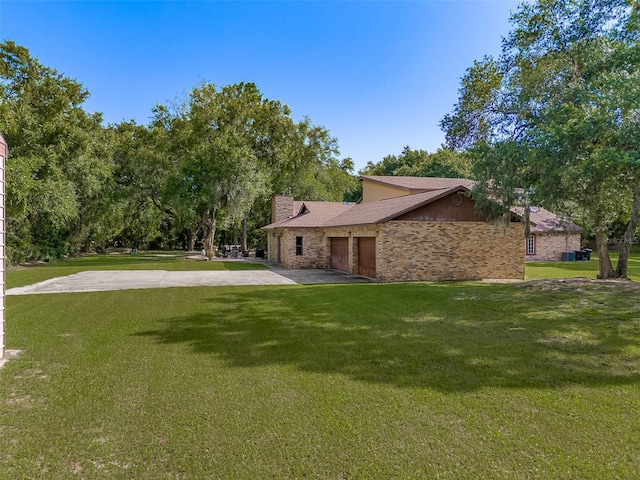 exterior space with a garage and a yard