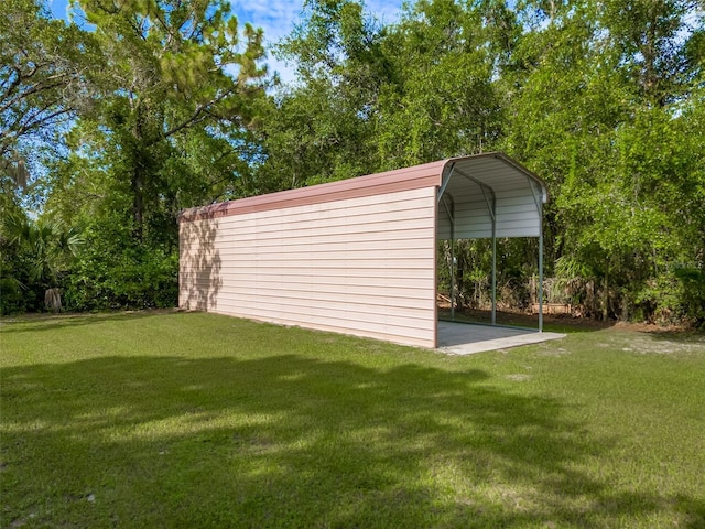 view of outdoor structure with a lawn and a carport