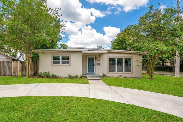 ranch-style home with a front lawn