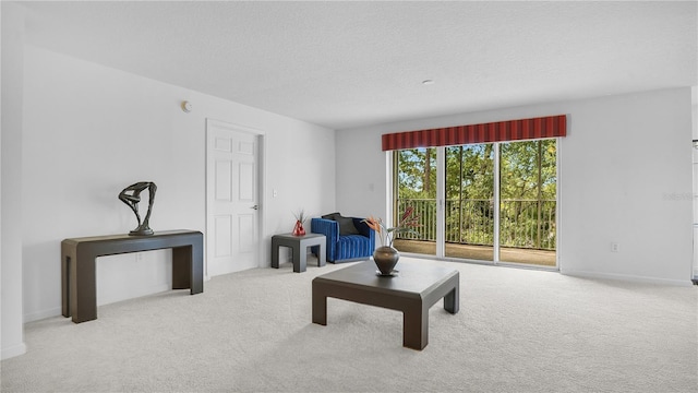 carpeted living room featuring a textured ceiling