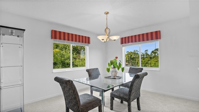 carpeted dining room with a healthy amount of sunlight