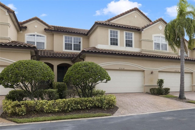 mediterranean / spanish-style house with a garage