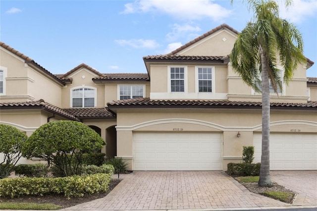 mediterranean / spanish-style house with a garage