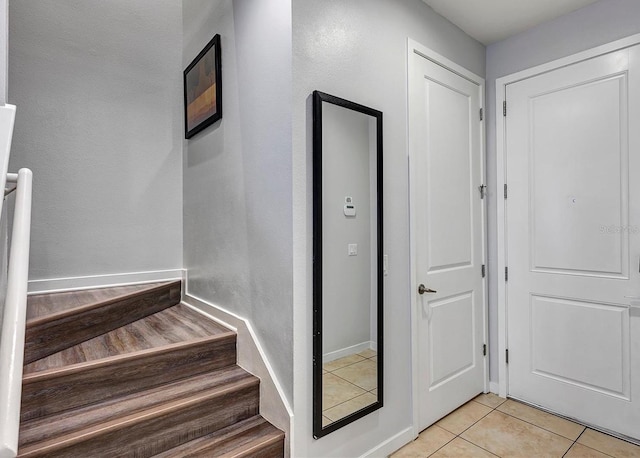 stairs featuring tile patterned flooring