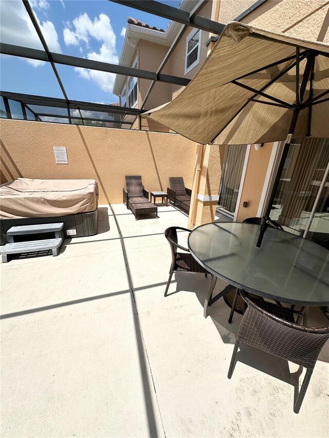 view of patio / terrace featuring a lanai