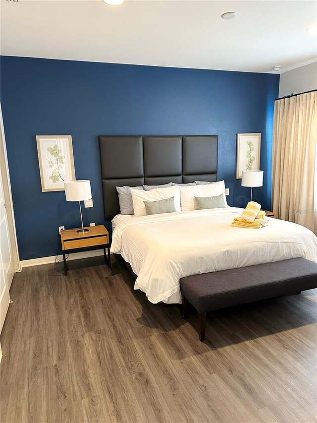 bedroom with hardwood / wood-style floors