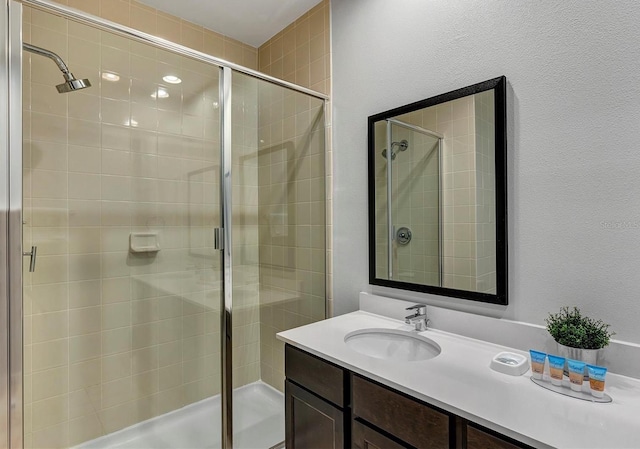 bathroom with vanity and a shower with shower door