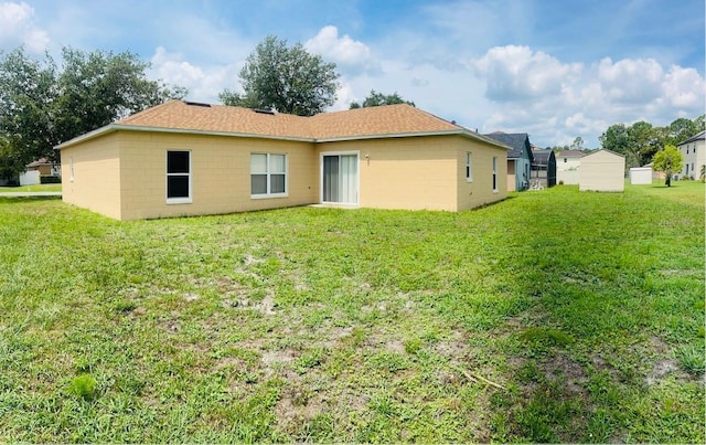 rear view of property featuring a lawn