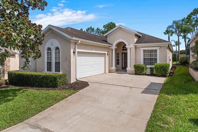 single story home featuring a garage and a front lawn