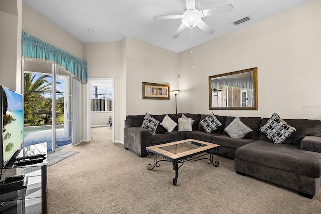 carpeted living room featuring ceiling fan