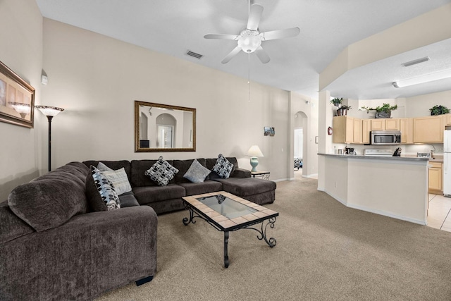 carpeted living room with ceiling fan