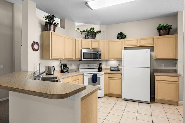 kitchen with light brown cabinets, white appliances, sink, light tile patterned floors, and kitchen peninsula