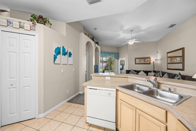 kitchen featuring a textured ceiling, dishwasher, and sink