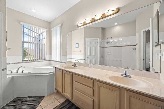 bathroom featuring tile patterned flooring, vanity, and shower with separate bathtub