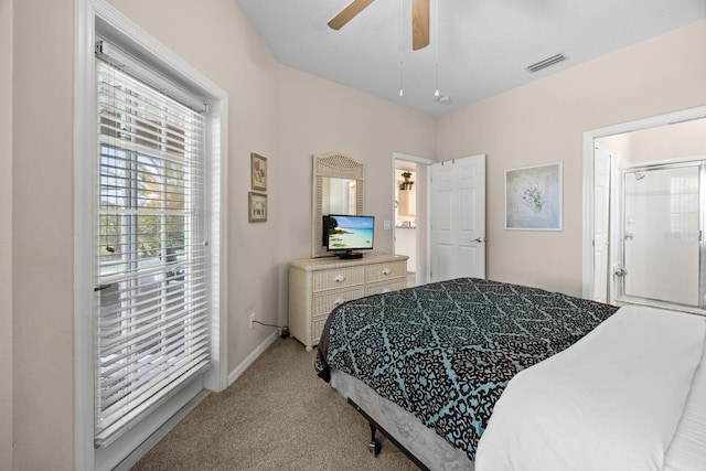 bedroom with connected bathroom, ceiling fan, and light carpet