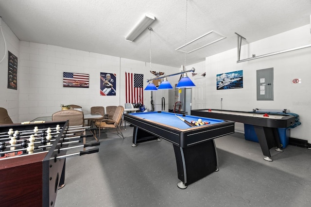 rec room with a textured ceiling, electric panel, and billiards