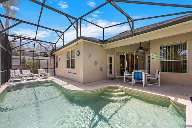 view of pool with a patio, ceiling fan, and a lanai