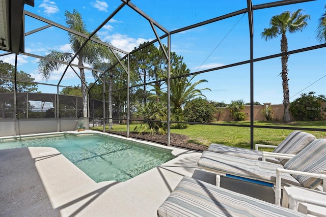 view of swimming pool featuring glass enclosure and a lawn