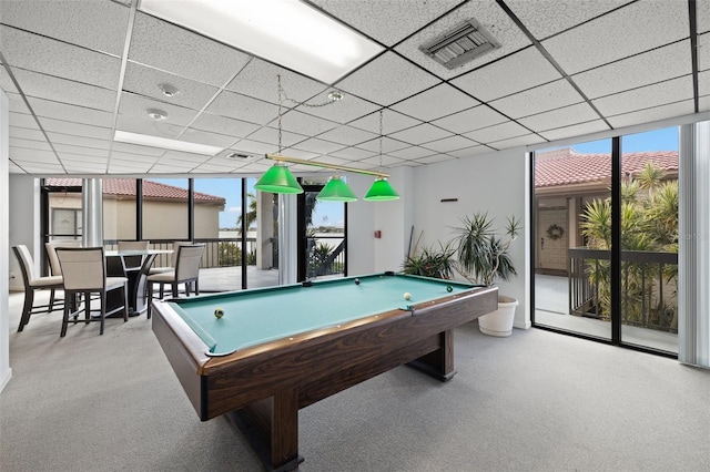 rec room with pool table, a paneled ceiling, light colored carpet, and floor to ceiling windows