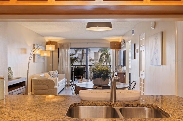 kitchen featuring sink and a textured ceiling