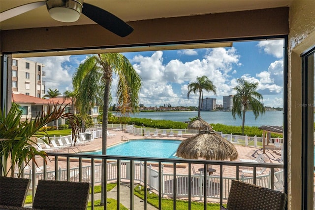 view of pool with a patio area and a water view