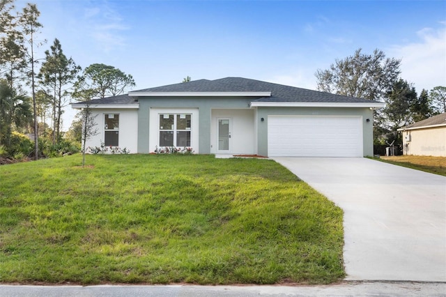 view of front of property featuring a garage and a front yard