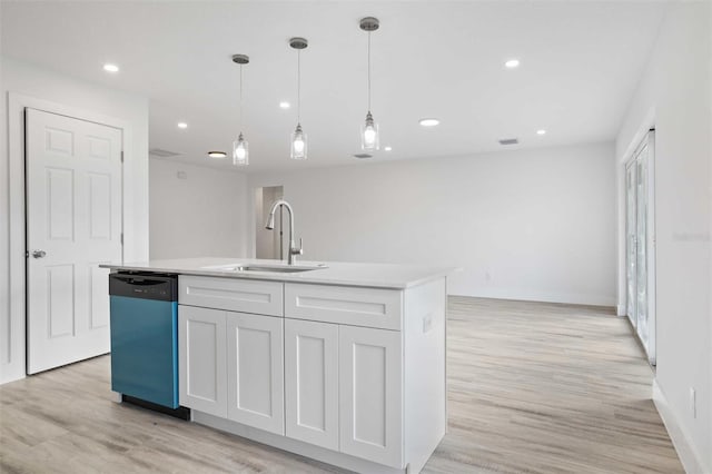 kitchen featuring a kitchen island with sink, sink, white cabinets, and dishwasher