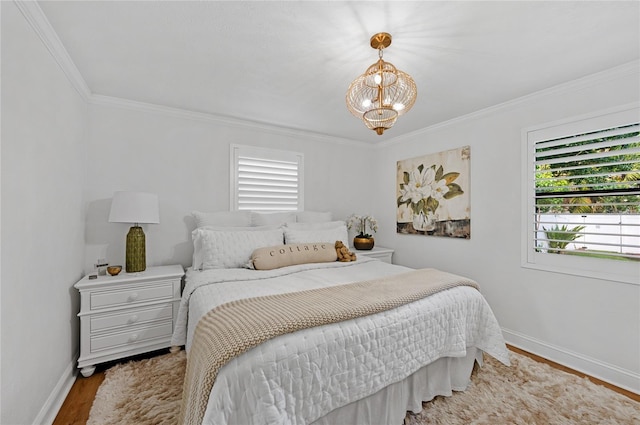 bedroom featuring a chandelier, hardwood / wood-style flooring, and ornamental molding