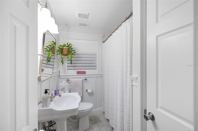 bathroom featuring tile patterned floors and toilet