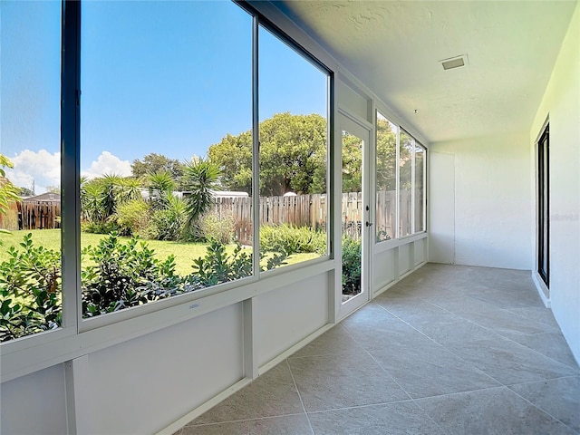 unfurnished sunroom featuring visible vents