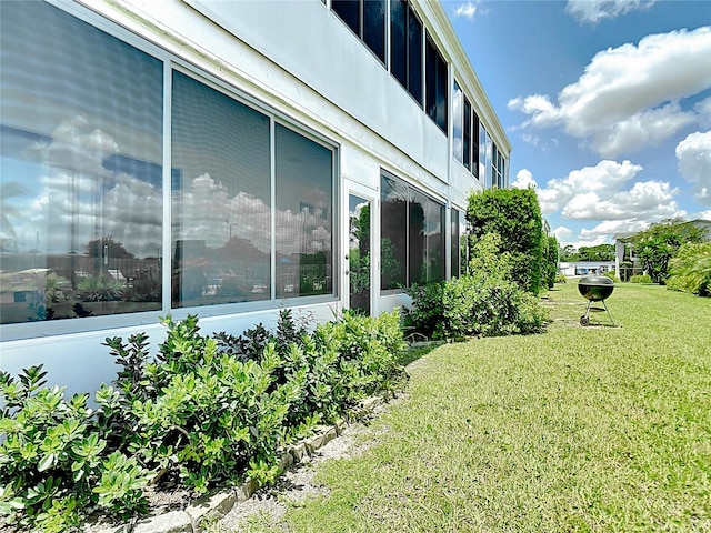 view of side of property with a yard