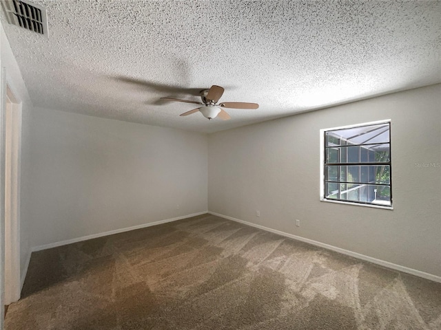 spare room with a textured ceiling, carpet floors, and ceiling fan