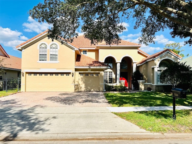 mediterranean / spanish-style house featuring a front yard