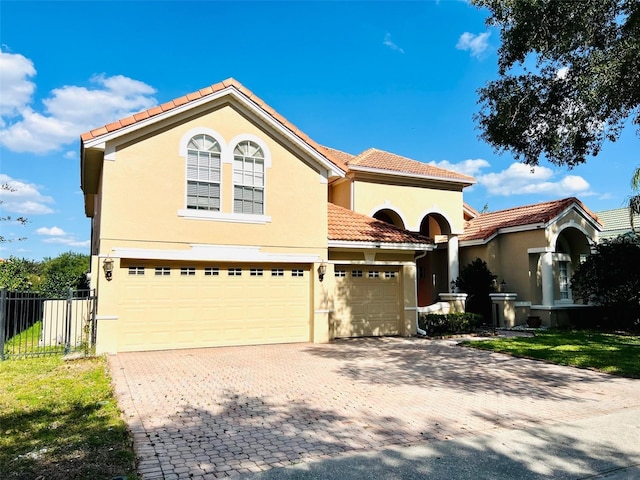 mediterranean / spanish house featuring a garage