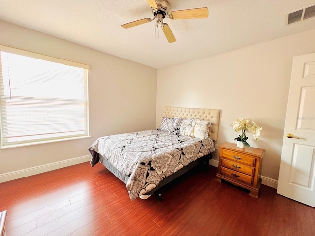 9060 Heritage Bay Cir, Orlando, FL 32836 - bedroom with a ceiling fan, wood finished floors, baseboards, and visible vents