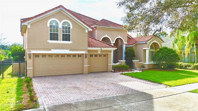 9060 Heritage Bay Cir, Orlando, FL 32836 - mediterranean / spanish home featuring stucco siding, a front lawn, a tiled roof, and decorative driveway