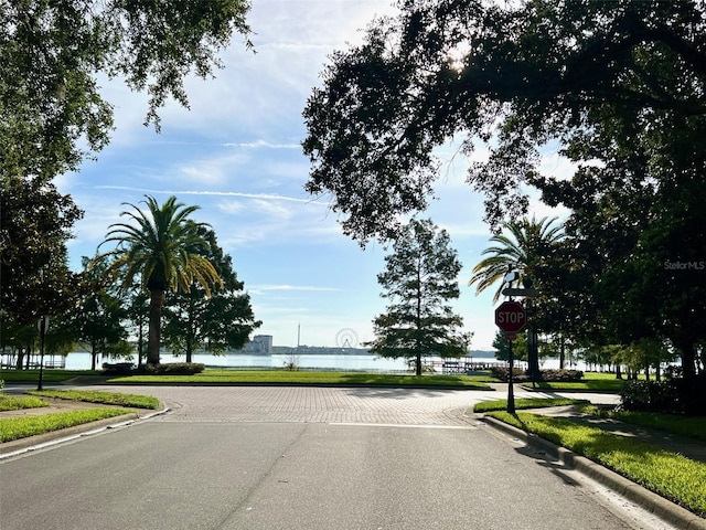 9060 Heritage Bay Cir, Orlando, FL 32836 - view of road featuring sidewalks, a water view, traffic signs, and curbs