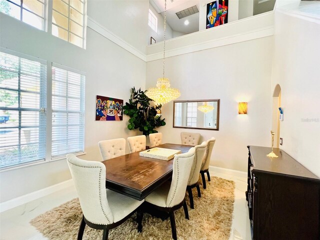 9060 Heritage Bay Cir, Orlando, FL 32836 - dining space featuring a high ceiling, arched walkways, and baseboards