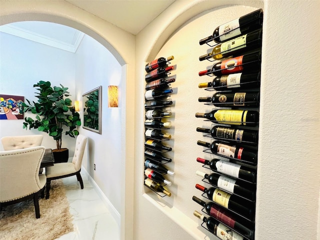 9060 Heritage Bay Cir, Orlando, FL 32836 - wine cellar with marble finish floor, baseboards, arched walkways, and ornamental molding