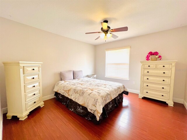 9060 Heritage Bay Cir, Orlando, FL 32836 - bedroom with dark wood-type flooring, ceiling fan, and baseboards